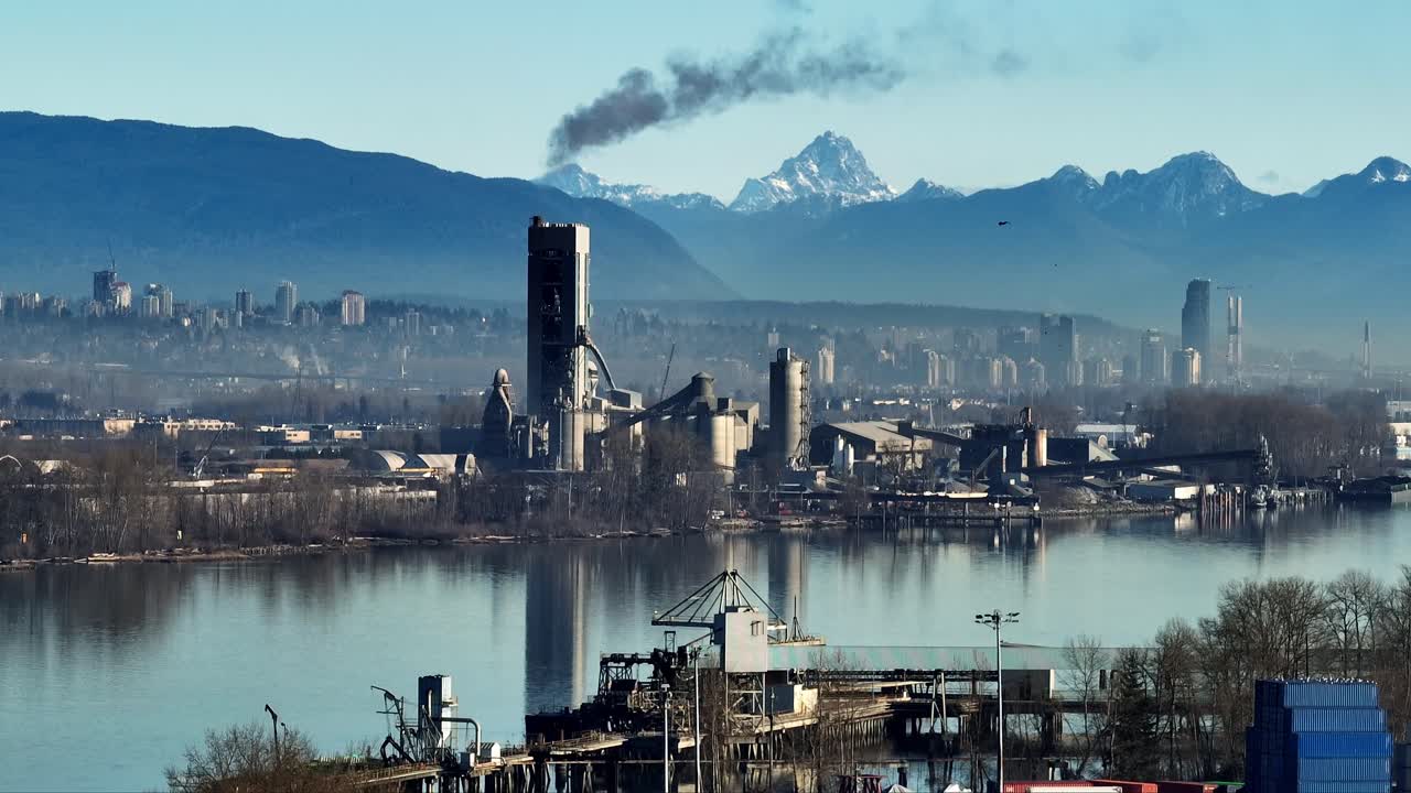 Cement Plant Production Area With High Concrete Factory And Cityscape Background Near Vancouver In BC Canada. Aerial Shot