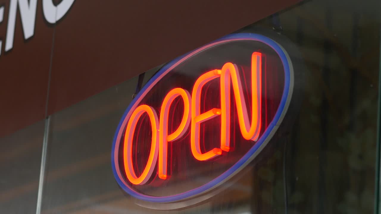 Open sign hanging front of cafe