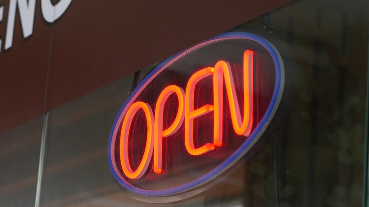 Open sign hanging front of cafe