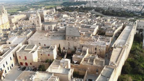 historic cityscape of mdina, overlooking st paul's cathedral - aerial upward reveal shot