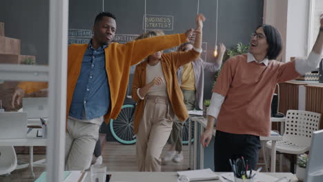 happy employees dancing in office