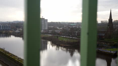 Looking-through-wrought-iron-metal-railing-to-suburban-waterfront-urban-highrise-dolly-right