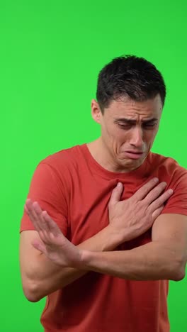 Man expressing sadness and crying on green screen