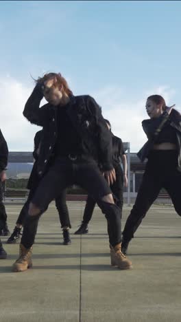 young street performer performing on the street. seven chinese teenagers dancing kpop
