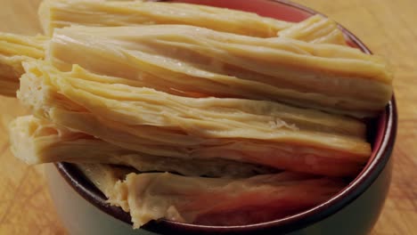 fermented soy food fuzhou, tofu skin yuba sticks or fuzhu on plate. healthy asian soy food, korean and chinese cuisine.