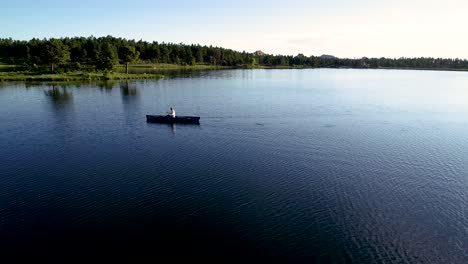 high mountain lake being navigated by a canoe