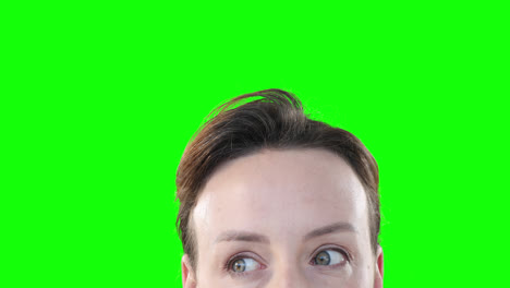 caucasian woman looking up on green background