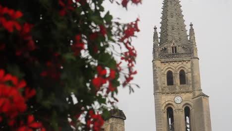 church tower and red flowers