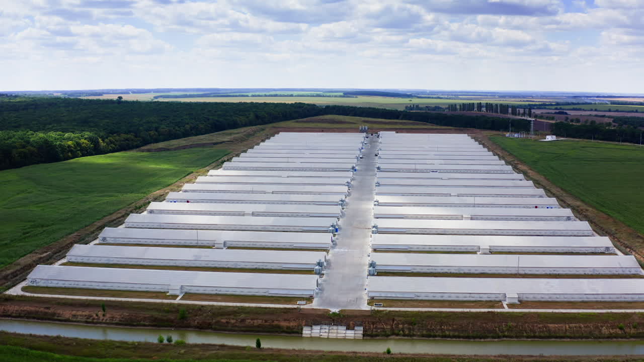 Agricultural new modern buildings in rural area. Poultry farm built in field. Industrial place for cattle growing. View from above.