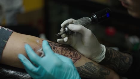 Close-up of a tattoo artist applying a new tattoo