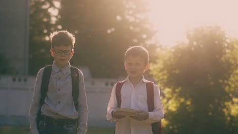 serious kids in school uniform walk after passing exam