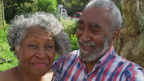 Animation-of-african-american-senior-couple-smiling-at-camera-in-garden