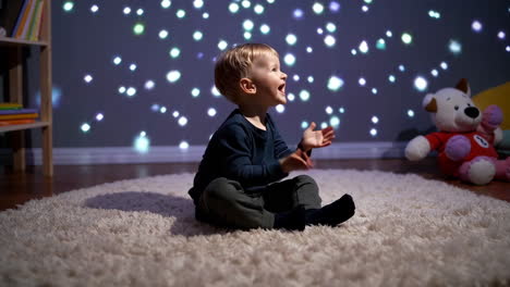 toddler in a playroom enchanted by starry projector lights