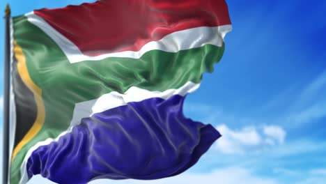 south african flag is waving slowly against blue sky
