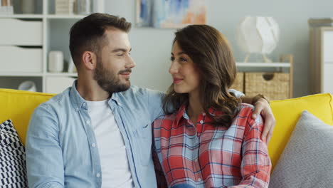 happy multiethnic couple drinking beer and dancing at disco