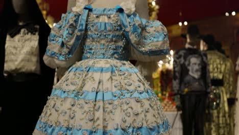 close-up view of exquisite vintage dresses with intricate beading and embroidery, showcasing historical fashion and craftsmanship.