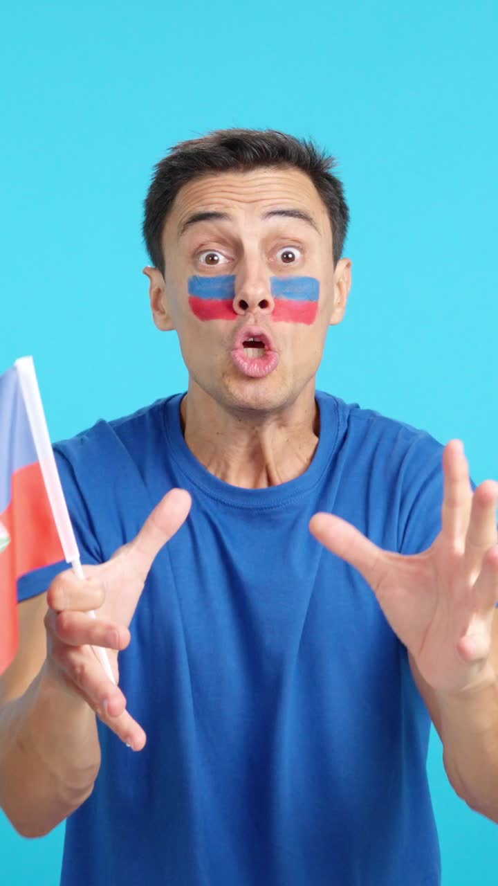 Man cheering for Haiti screaming and waving a national flag
