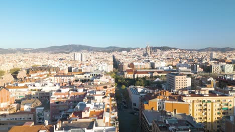 drone flies over residential buildings to reveal la sagrada familia