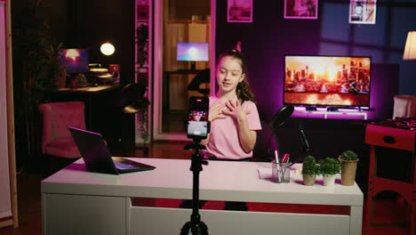 energetic young girl filming herself discussing topics of interest for children watching her