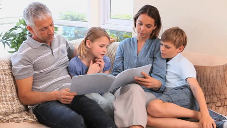 happy family reading a book together