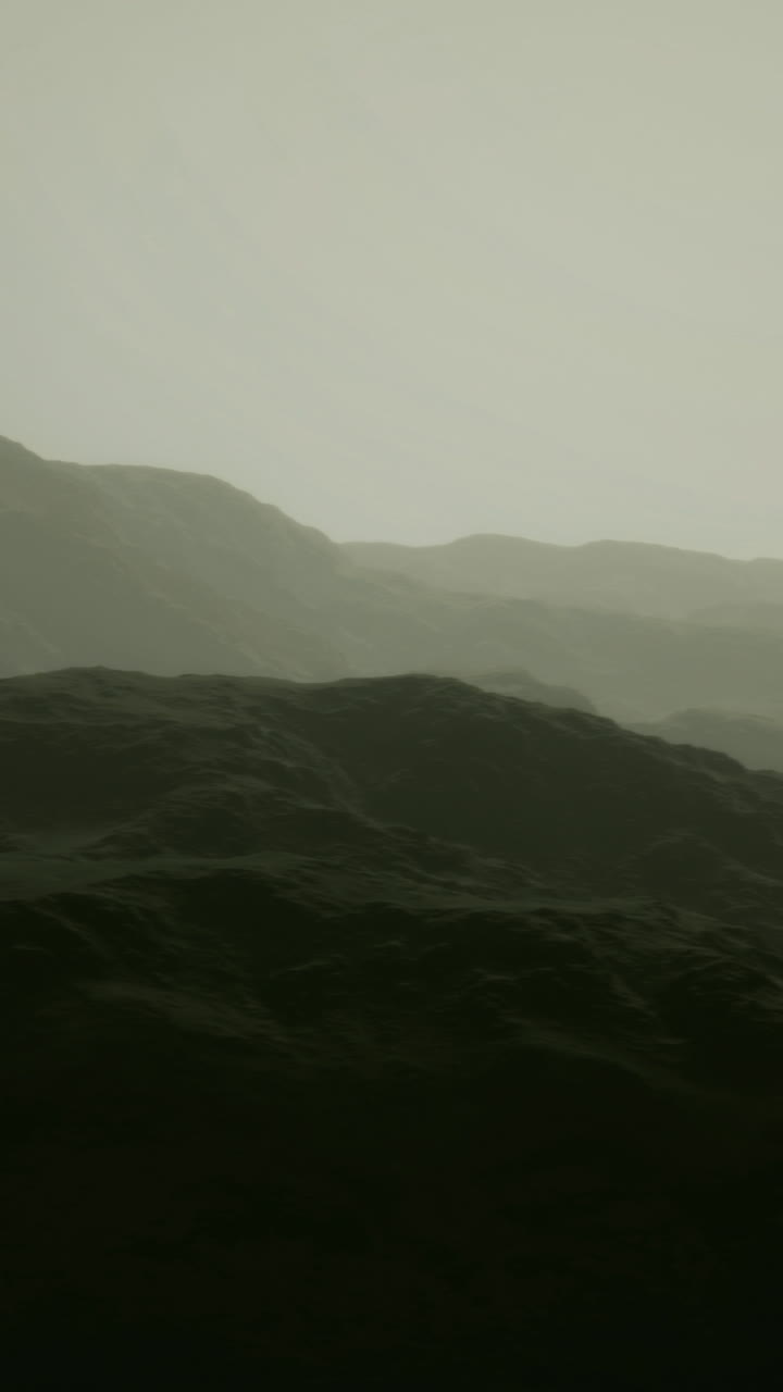 Misty mountain landscape with soft light enveloping the rugged terrain