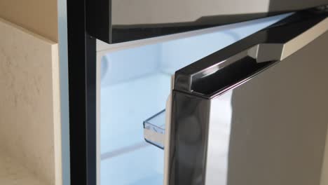 close-up of an open black refrigerator door