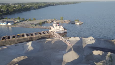 sand excavated from the water with a dredging vessel at the sea port in kingsville, ontario, canada - aerial shot