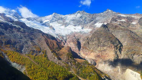 Saastal-Saas-Fee-Switzerland-tram-ride-top-of-Swiss-Alps-glacier-mountain-peaks-summer-morning-stunning-vibrant-clear-blue-sky-alpine-valley-fresh-snow-dusting-larks-Zermatt-Alphabel-upward-slide-left