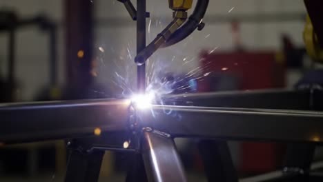 Close-Up of Robotic Welding Process Emitting Sparks as Metal Joins, Showcasing Precision and Technology in Industrial Manufacturing Environments