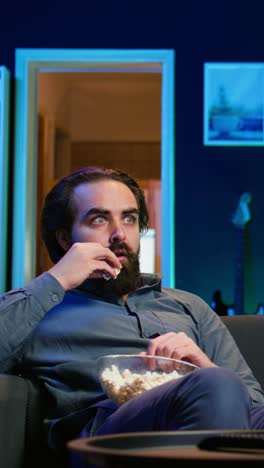 vertical video stupefied man at home left with eyes wide open by dramatic movie plot twist