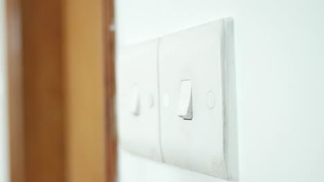 a finger turning on lighting switch