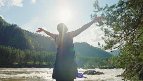 woman enjoying a scenic view of a mountain river in nature