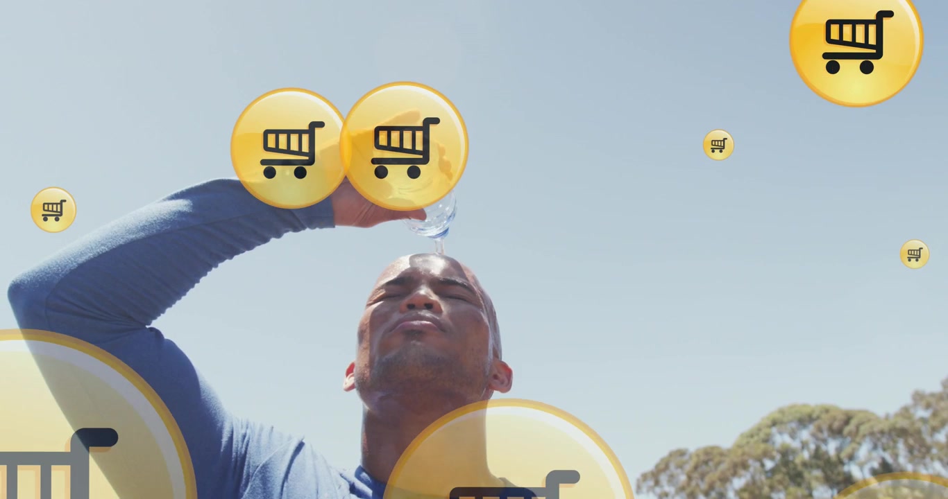 Animation of shopping cart icons over african american athlete pouring water on head against sky
