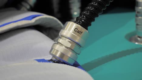 Slow motion shot of pump connectors connected to a patient&#039;s calf for heart problems