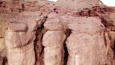 tall solomon pillars in the eroded rocks of the red canyon in the dry timna park in the negev desert in southern israel