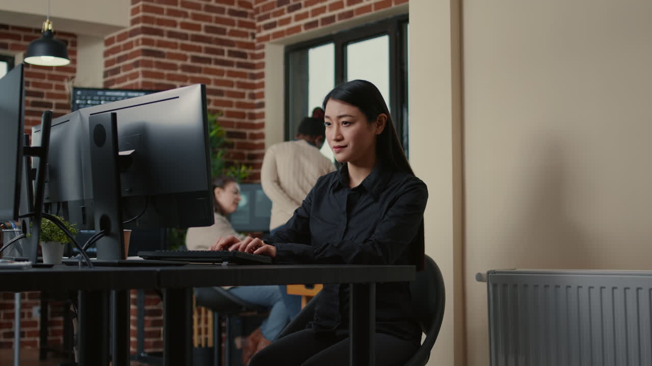 Portrait of focused system engineer happy with parsing results sitting at desk