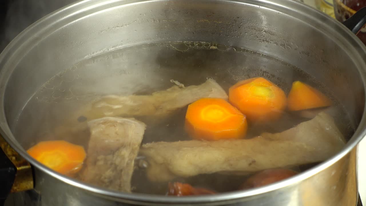 Beef with onions and carrots cooked in broth. Shooting in kitchen