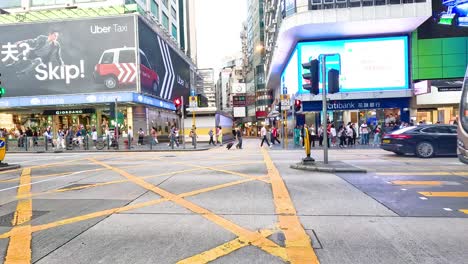 buses and pedestrians in bustling urban intersection