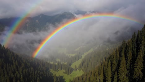 double rainbow over alpine valley