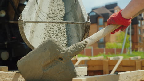 pour concrete from the mixer into the formwork in the background blurred new buildings construction