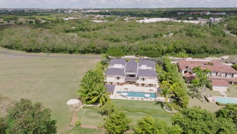 luxury villa with outdoor pool on caribbean coastline of la romana, dominican republic. aerial orbiting shot