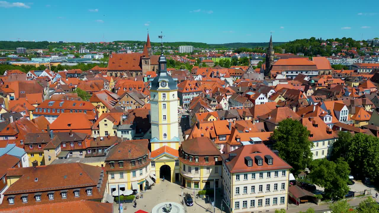 4K Aerial Drone Video of the Historic Herrieder Clock Tower, St. Johannis Church, and St. Gumbertus Church in the Old Town area of Downtown Ansbach, Germany