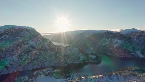 big bright sun with massive sun rays setting over mesmerizing veafjorden - norway winter landscape panning shot