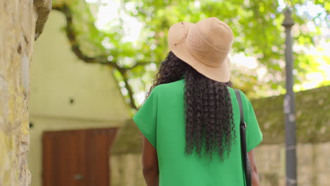 rear view of female tourist on vacation in oxford uk exploring city street walking along lamb and flag passage 1