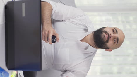 Vertical-video-of-Home-office-worker-sprays-perfume-on-man.