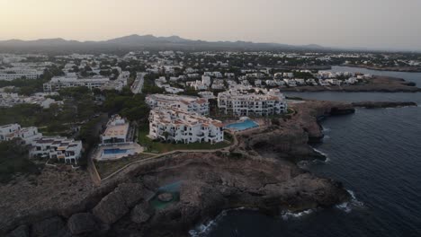 establishing aerial view rising over mallorca holiday resort hotel overlooking mediterranean sea coastal cliff edge