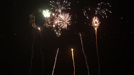 Fireworks-firing-and-exploding-on-night-sky-with-glowing-stars-and-sparkle-trails-3D-animation