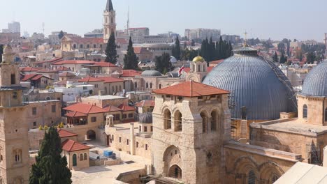 christian priest comes out of the interior of the temple of the holy sepulcher