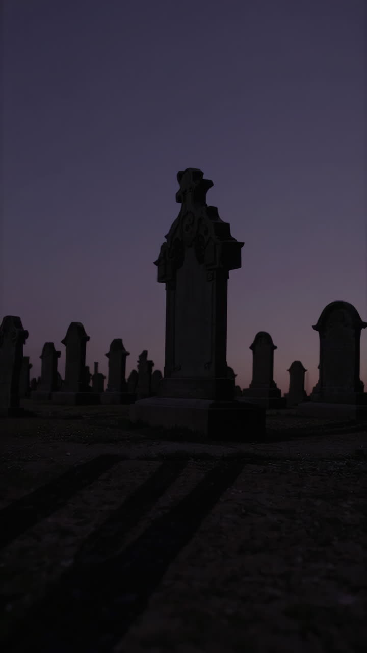 Silhouette of Tombstones in a Graveyard at Dusk