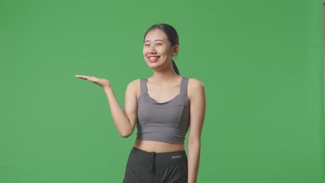 woman in sportswear posing on green screen